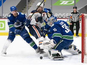 Thatcher Demko makes a save on Connor McDavid as the Vancouver Canucks host the Edmonton Oilers Saturday at Rogers Arena.