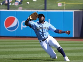 Seattle Mariners outfielder Taylor Trammell makes a sliding catch to take a hit away from Tim Locastro of the Arizona Diamondbacks in a spring training game at Peoria Sports Complex on March 15 in Peoria, Arizona.