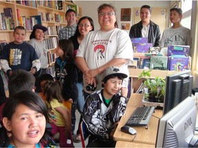 Stoney Williams, centre, is the librarian at Toosey Reserve at Riske Creek. Her library, and 18 others, were made possible through the volunteers of B.C.'s Write to Read Project.