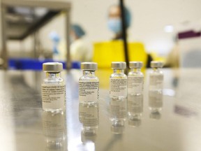 University Health Network technicians prepare syringes of the Pfizer-BioNTech COVID-19 vaccine for front-line health-care workers at a clinic at the MaRS building in Toronto, Jan. 7, 2021.