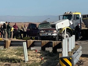In this image from KYMA law enforcement work at the scene of a deadly crash involving a semitruck and an SUV in Holtville, Calif., on Tuesday, March 2, 2021.