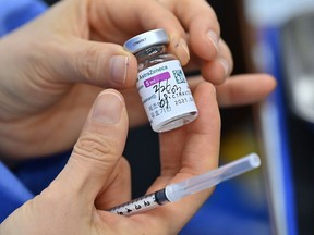 A nurse prepares to administer a dose of the AstraZeneca COVID-19 vaccine.