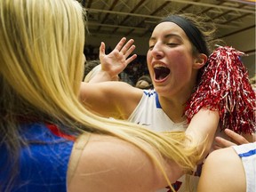 The Brookswood Bobcats' Aislinn Konig, right, celebrates with fans the team's win over the R.A. McMath Wildcats in the AAA girls basketball championship final at the LEC on March 5 2016.