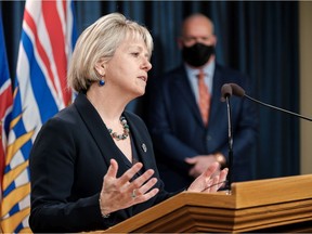 Provincial health officer Dr. Bonnie Henry. In the background is Premier John Horgan.