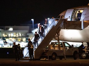 Canucks players, led by Tyler Myers at the bottom of the steps, get off the team’s charter plane from Phoenix at Vancouver International Airport on March 12 of last year. When the NBA suspended its season due to COVID-19 the night before, ‘that's when it kind of clued in for us,’ says Myers.