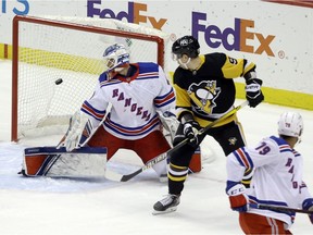 Pittsburgh Penguins centre Evan Rodrigues (9) looks on as a shot by defenseman John Marino (not pictured) goes past New York Rangers goaltender Alexandar Georgiev (40) for a goal during the first period at PPG Paints Arena.