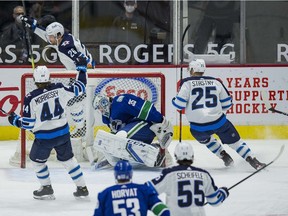 Winnipeg Jets forward Blake Wheeler (26) and defenceman Josh Morrissey (44) and forward Paul Stastny (25) celebrate Wheeler's goal scored on Vancouver Canucks goalie Thatcher Demko (35) in the first period at Rogers Arena.