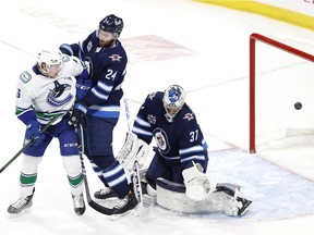 Vancouver Canucks centre J.T. Miller (9) (not shown) scores on Winnipeg Jets goaltender Connor Hellebuyck (37) in the first period at Bell MTS Place.