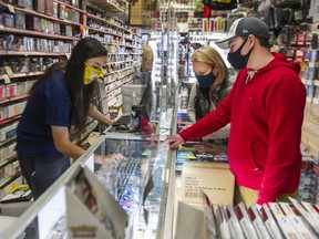 Customers Heather Roloff and her son Kirkland Roloff shop for cards at Pastime Sports and Games in Langley.