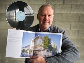 Brian Roche, president of Rendition Developments, with a record and a brochure of the Fifth + Columbia building in Vancouver, on March 9. Roche worked with Rob Edmonds to produce a vinyl music album and Spotify list of nine songs by local artists.