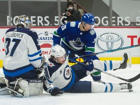 Tucker Poolman helps ward off a scoring chance by Antoine Roussel during a March 24 meeting.