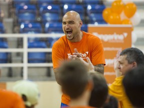 Rob Sacre encourages some kids during a basketball camp at the University of B.C. in 2016.