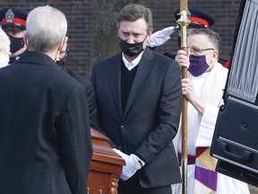 Wayne Gretzky sheds a few tears as the casket containing his father Walter is loaded into the back of a hearse after his funeral at St. Mark's Anglican Church in Brantford on Saturday, March 6, 2021.