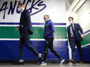 Vancouver Canucks defenceman Nate Schmidt (centre) has tested positive for the coronavirus.