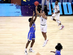 Jalen Suggs of the Gonzaga Bulldogs shoots a game-winning three-point basket in overtime to defeat the UCLA Bruins 93-90 in the NCAA semfinal at Lucas Oil Stadium in Indianapolis Saturday.