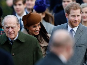 In this file photo taken on Dec. 25, 2017, Britain's Prince Philip, Meghan Markle and Prince Harry arrive to attend the Royal Family's traditional Christmas Day church service at St Mary Magdalene Church in Sandringham, Norfolk.