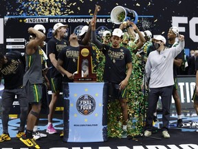 Members of the Baylor Bears celebrate with the trophy after defeating the Gonzaga Bulldogs 86-70 in the championship game of the 2021 NCAA men's basketball tournament at Lucas Oil Stadium in Indianapolis on April 5, 2021.