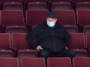 Vancouver Canucks general manager Jim Benning watches the NHL team's training camp in Vancouver, on Jan. 5, 2021.