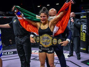 Lupita (Loopy) Godinez has the straw-weight championship belt wrapped around her waist after beating Vanessa Demopolous in October.