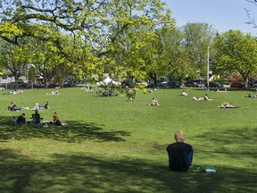 Sunbathers enjoying the sunny and warm weather this weekend at Robson Park in Vancouver.