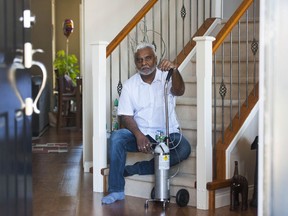Atish Ram with an oxygen machine inside his Surrey home.
