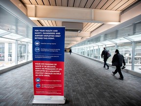 People walk towards Terminal 1 at Toronto's Pearson Airport after mandatory coronavirus (COVID-19) testing took effect for international arrivals February 15, 2021.