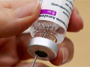 A medical worker prepares a dose of Oxford/AstraZeneca's COVID-19 vaccine at a vaccination centre in Antwerp, Belgium March 18, 2021.
