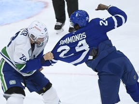 Toronto Maple Leafs forward Wayne Simmonds (24) fights Vancouver Canucks defenceman Alexander Edler (23) during first period NHL hockey action in Toronto on Thursday, April 29, 2021.