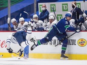 Vancouver Canucks defenceman Alex Edler (right) and Toronto Maple Leafs winger Zach Hyman collide during the second period of their NHL game at Rogers Arena on Sunday. Edler received a major penalty for kneeing and a game misconduct on the play.