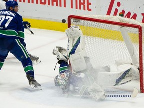 Vancouver Canucks goalie Braden Holtby  makes an acrobatic save against the Toronto Maple Leafs at Rogers Arena on Sunday.