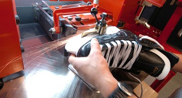 Vancouver Canucks' Pat O'Neill sharpens skates before practice at then-GM Place in October 2007.