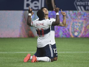 Vancouver Whitecaps forward Fredy Montero (12) celebrates his goal with midfielder Cristian Dajome (11) after scoring against the Montreal Impact .