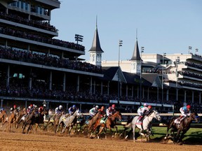 Medina Spirit #8, ridden by jockey John Velazquez, leads the field around the first during the 147th running of the Kentucky Derby at Churchill Downs on May 1, 2021 in Louisville, Kentucky.