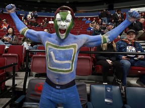 A fan cheers before the NHL game between the Vancouver Canucks and the Edmonton Oilers at Rogers Arena on January 16, 2019.