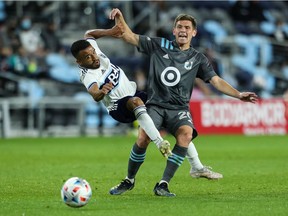 Vancouver Whitecaps midfielder Caio Alexandre tangles with Minnesota United's Will Trapp during their May 12 game at Allianz Field in St. Paul, Minn. United beat the Whitecaps 1-0. Adapting to the physical, athletic style of MLS is just one of the differences for Vancouver's Brazilian newcomer.
