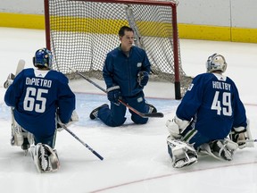 Mike DiPietro and Braden Holtby listen attentively to Canucks goalie coach Ian Clark during training camp in January. ‘Clarkie has allowed me to still be Michael DiPietro the goaltender who battles and competes, but also in more controlled ways, you know, having better footwork,’ says DiPietro, still considered a top prospect.