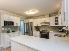The new kitchen has been finished with quartz counters, an undermount sink, and soft-close cupboards.