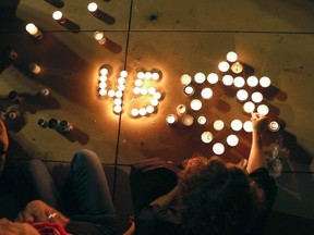 People light candles during a vigil in Habima Square in Tel Aviv on Saturday, May 1, 2021, a day after a deadly stampede left dozens dead and injured in a northern Jewish pilgrimage town.