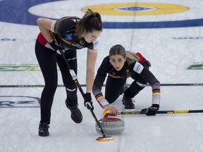 Germany skip Daniela Jentsch delivers a stone as only one teammate -- sister Analena Jentsch -- sweeps during their game against Canada at the world women's curling championship in Calgary on May 3, 2021. Germany, with only three players, defeated Canada 6-2. / Michael Burns Photo