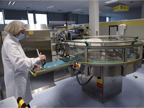 An employee works on a production line at the factory of British multinational pharmaceutical company GlaxoSmithKline (GSK) in Saint-Amand-les-Eaux, northern France, on December 3, 2020, where the adjuvant for Covid-19 vaccines will be manufactured. - Canada's Medicago and British pharmaceutical giant GlaxoSmithKline (GSK) announced on December 3, 2020 the launch of phase 2 and 3 clinical trials on a Covid-19 vaccine, one of a series of candidates being developed worldwide. Final phase 3 trials of the plant-derived vaccine candidate will begin by year's end and will be tested on 30,000 volunteers in North America, Latin America and Europe, according to a joint statement.