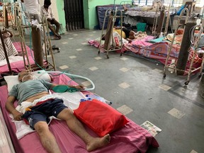 COVID-19 patients receive medical treatment at a ward of the Siliguri District Hospital in India