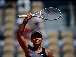 In this file photograph taken on May 30, 2021, Japan's Naomi Osaka celebrates after winning against Romania's Patricia Maria Tig during their women's singles first round tennis match on Day 1 of The Roland Garros 2021 French Open tennis tournament in Paris.