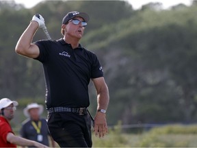 Phil Mickelson hits from the 16th tee during the third round of the PGA Championship golf tournament.