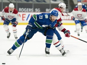 Veteran blueliner Alex Edler (left) may no longer have the foot speed, but he still has the size and strength to deal with the likes of Montreal Canadiens power forward Josh Anderson.