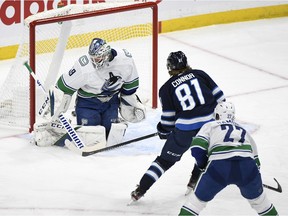 CP-Web. Winnipeg Jets' Kyle Connor (81) scores on Vancouver Canucks goaltender Braden Holtby (49) during first period NHL action in Winnipeg on Tuesday May 11, 2021.