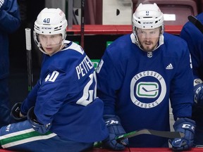 J.T. Miller (right) will be happy to have linemate Elias Pettersson back at the start of next season.
