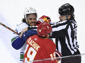Calgary Flames forward Matthew Tkachuk battles with Vancouver Canucks defenceman Jalen Chatfield during their National Hockey League game at the Scotiabank Saddledome in Calgary on May 19, 2021.