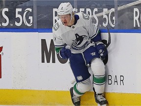 Vancouver Canucks defenceman Jack Rathbone (3) celebrates a first period goal against the Edmonton Oilers at Rogers Place.