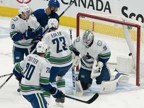 Vancouver Canucks goaltender Thatcher Demko (35) is unable to stop the puck on a shot  by Toronto Maple Leafs center Auston Matthews during the second period at Scotiabank Arena.