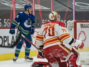 Canucks rookie Nils Höglander, the team's most exciting player as voted on by fans, looks ready to celebrate his first-period goal with teammates after beating Calgary Flames netminder Loius Domingue at Rogers Arena on Tuesday.